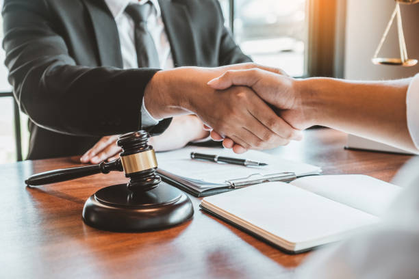 Experienced attorney reviewing legal documents and case files at their desk
